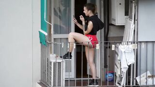 Nice teen enjoying the call on the balcony