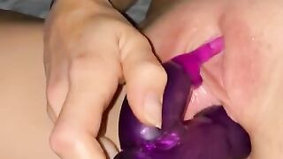 Wife plays with toy while husband fingers her ass