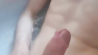 Teen playing with his big dick while bathing