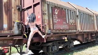 Dancing naked Outdoor among old trains