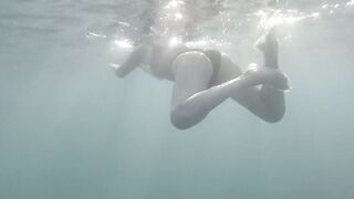 Swimming and peeping on Acquatica, dressed in a black one-piece swimsuit, spyng on legs and feet