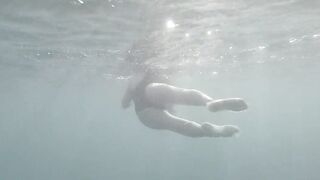 Swimming and peeping on Acquatica, dressed in a black one-piece swimsuit, spyng on legs and feet