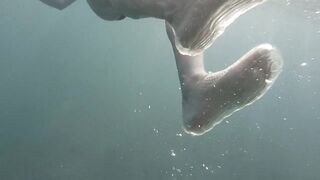 Swimming and peeping on Acquatica, dressed in a black one-piece swimsuit, spyng on legs and feet