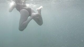 Swimming and peeping on Acquatica, dressed in a black one-piece swimsuit, spyng on legs and feet