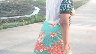 Auntie walks and shows off her breasts on the side of the road.