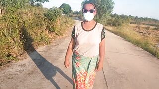 Auntie walks and shows off her breasts on the side of the road.