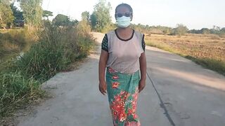 Auntie walks and shows off her breasts on the side of the road.